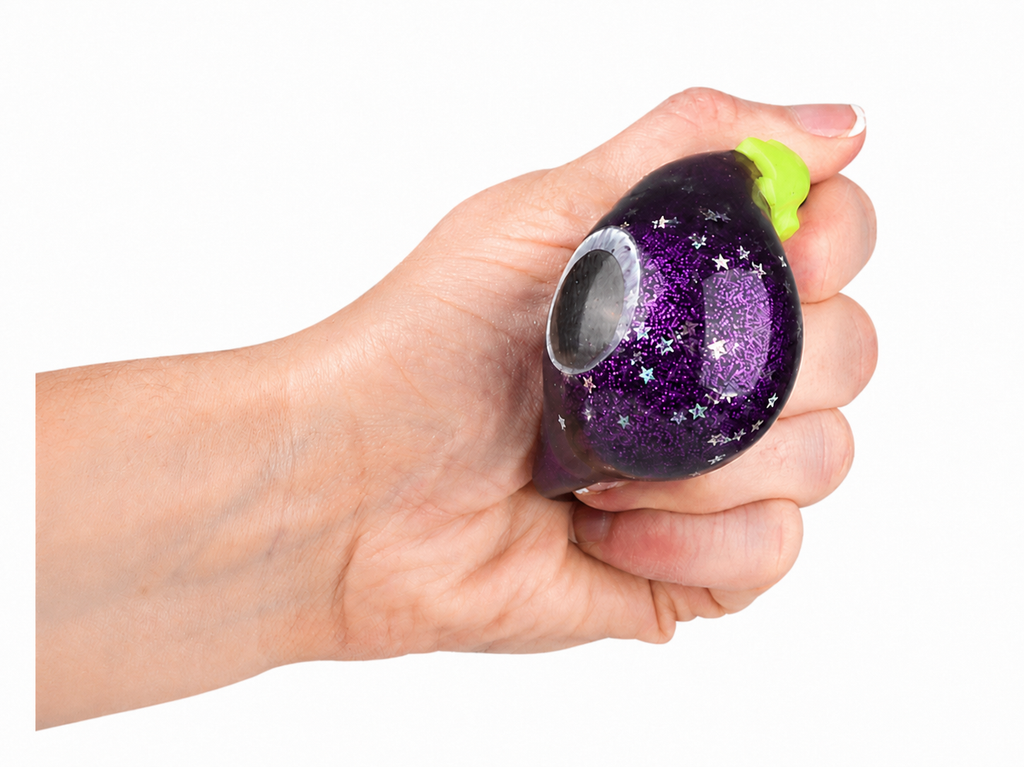 Hand squeezing a purple glitter grape squishy toy with green stem